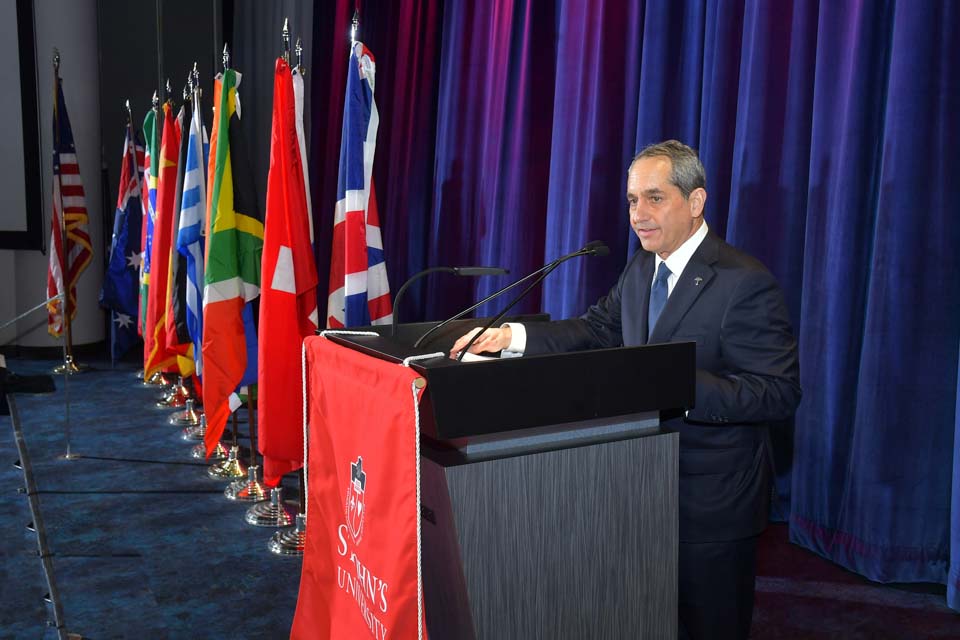 Alan Schnitzer speaking at a St. John’s University lectern during his Insurance Leader of the Year award dinner