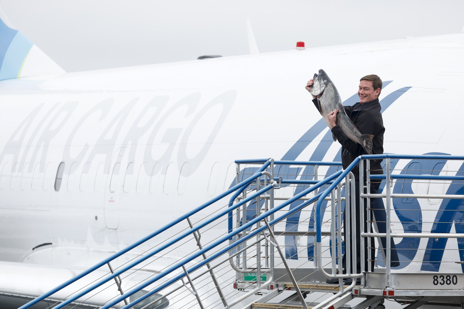 Alaska captain Kevin Yarbrough holding a Copper River Chinook salmon at Seattle-Tacoma airport