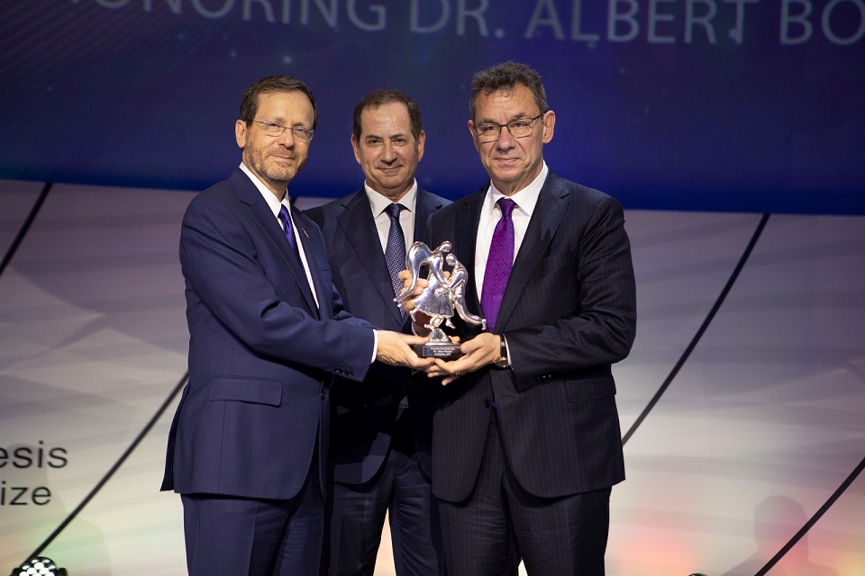 Albert Bourla, right, holds the Genesis Prize with Isaac Herzog, left, and Stan Polovets, center, in Jerusalem