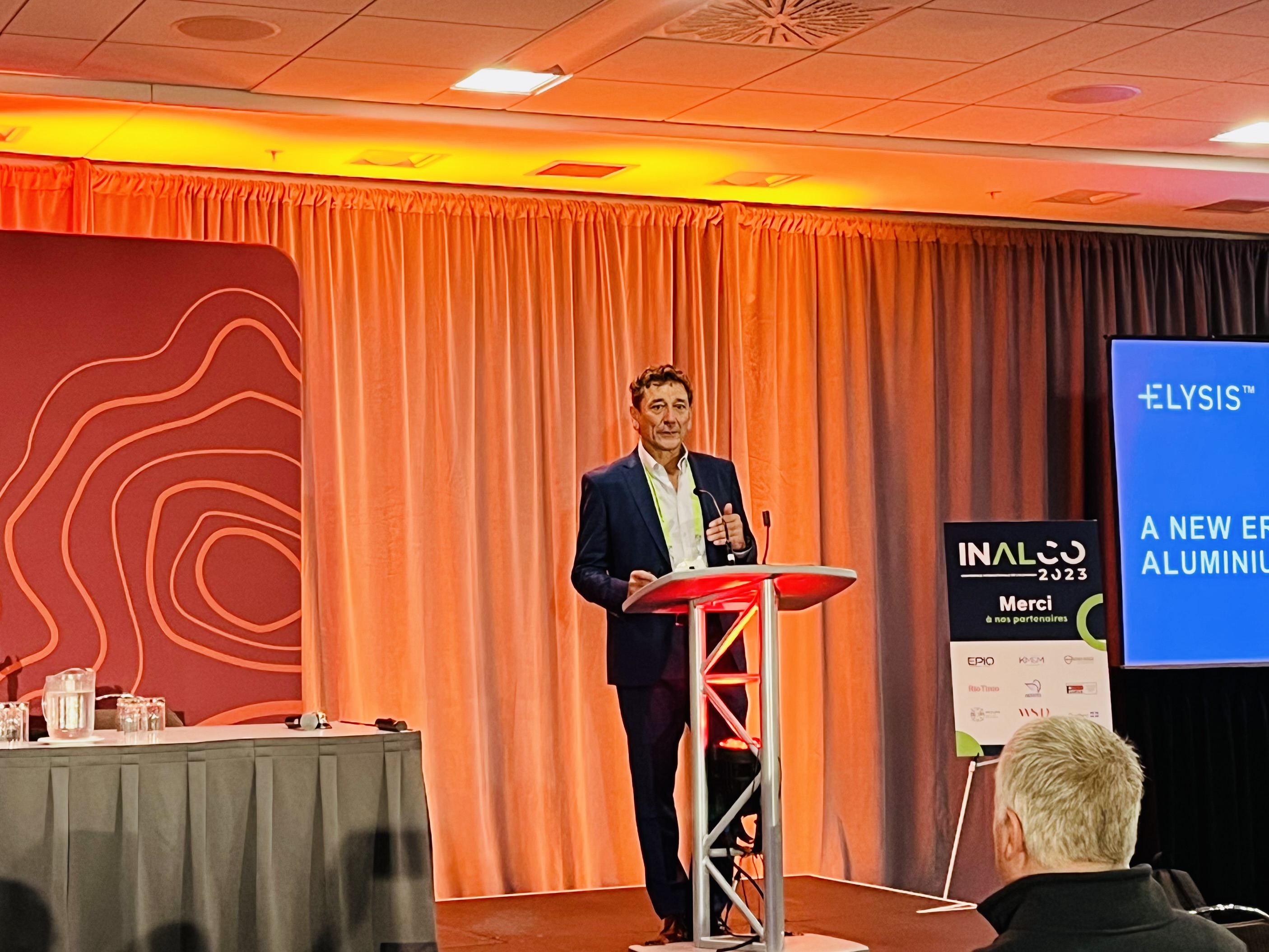 Vincent Christ, then CEO of ELYSIS, speaking beside an ELYSIS display at INALCO 2023