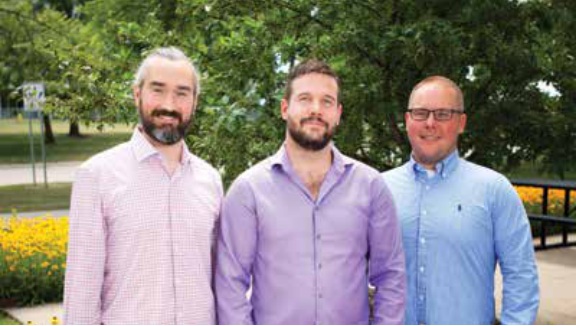 HLT co-founders Adam Keune, Alec Whitters and Ben O'Connor standing outdoors at a University of Iowa entrepreneurship event