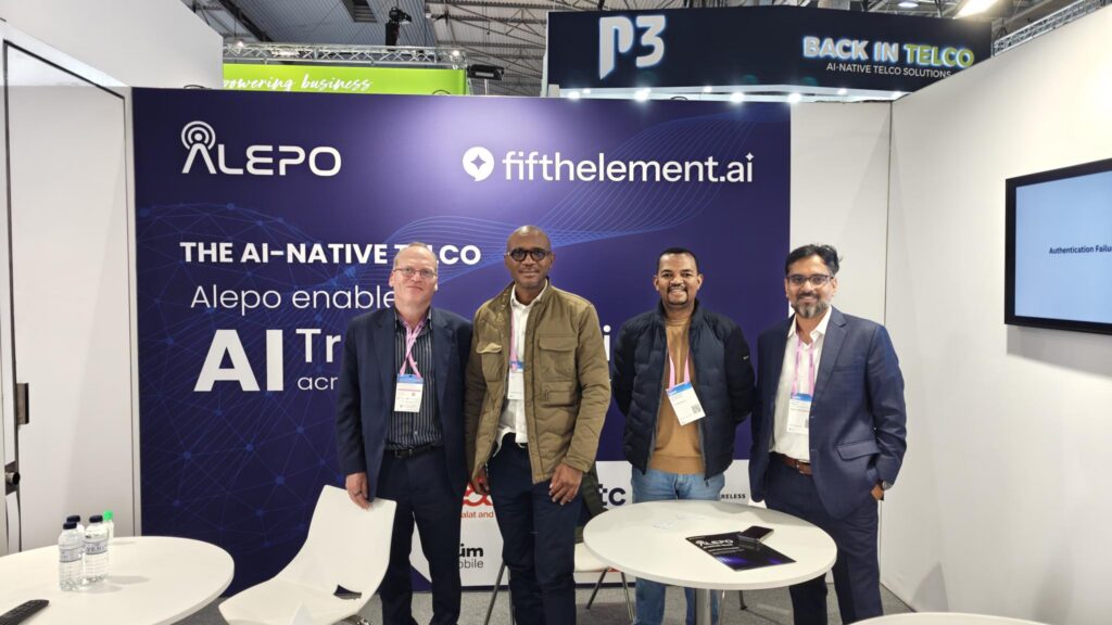 Four representatives at an Alepo and FifthElement.ai telecom exhibition booth