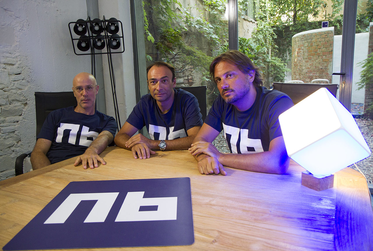 Nana Bianca founders Jacopo Marello, Alessandro Sordi and Paolo Barberis seated around a wooden table
