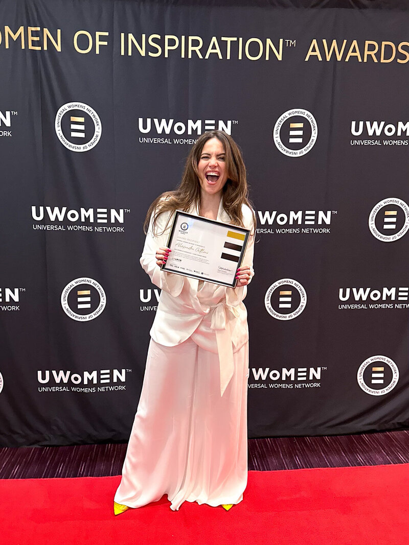 Alex Cattoni holding her Women of Inspiration award certificate