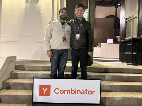 Alex Chantavy and Kunaal Sikka standing beside a Y Combinator sign