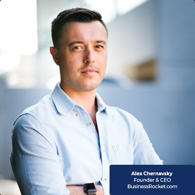 Alex Chernavsky in a light blue shirt, in a BusinessRocket company photograph