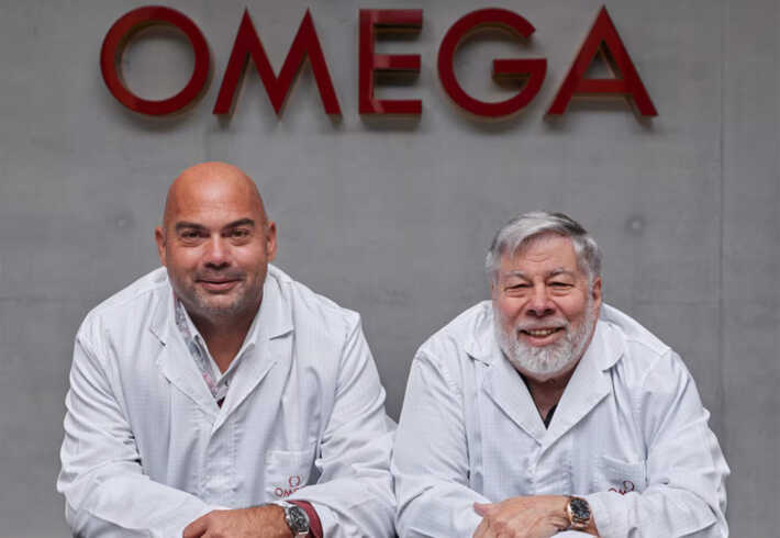 Alex Fielding, left, and Steve Wozniak wearing white coats during a visit to OMEGA