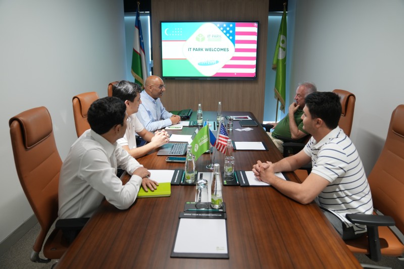 Alex Karpovsky, wearing green at the right of the table, meets representatives of IT Park Uzbekistan