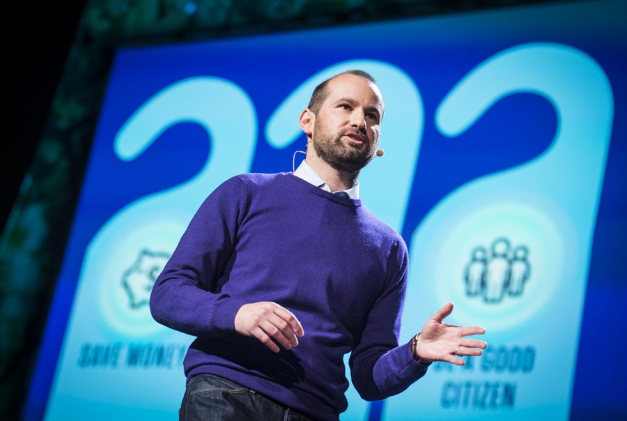 Alex Laskey speaking at TED2013 beside slides about saving money and being a good citizen