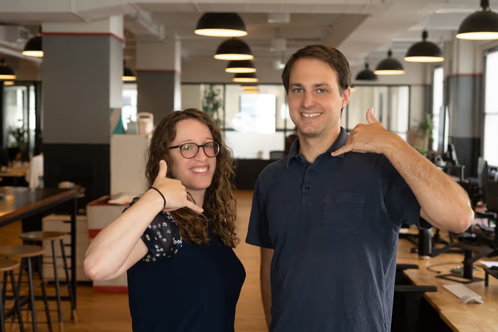 Rebecca Greene and Alex Levin making phone gestures at Regal’s New York office