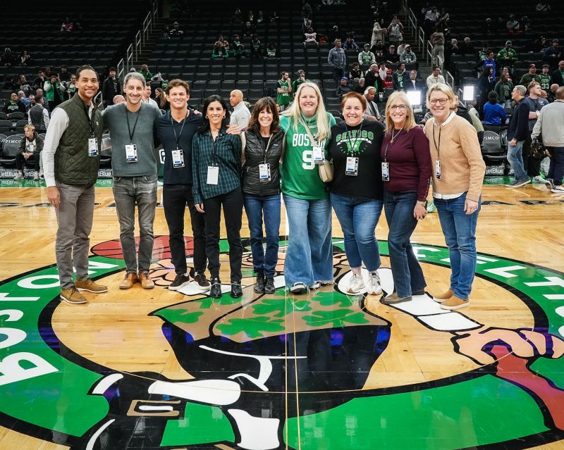 Alex Marcus, Jamie Albers and fellow attendees on the Boston Celtics court at a Mento HR leadership gathering