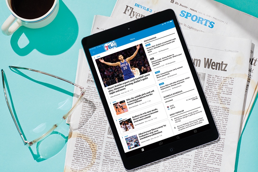 The Athletic’s Philadelphia coverage displayed on a tablet on top of a newspaper sports section