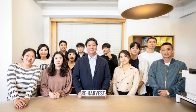 Alex Min standing with the RE:harvest team in their Seoul office