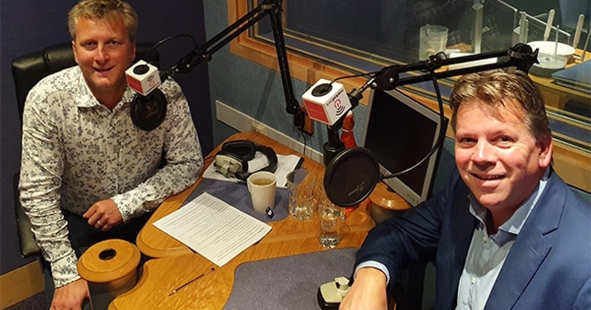 Alex Northcott, right, and host Ben Smith at microphones in a recording studio