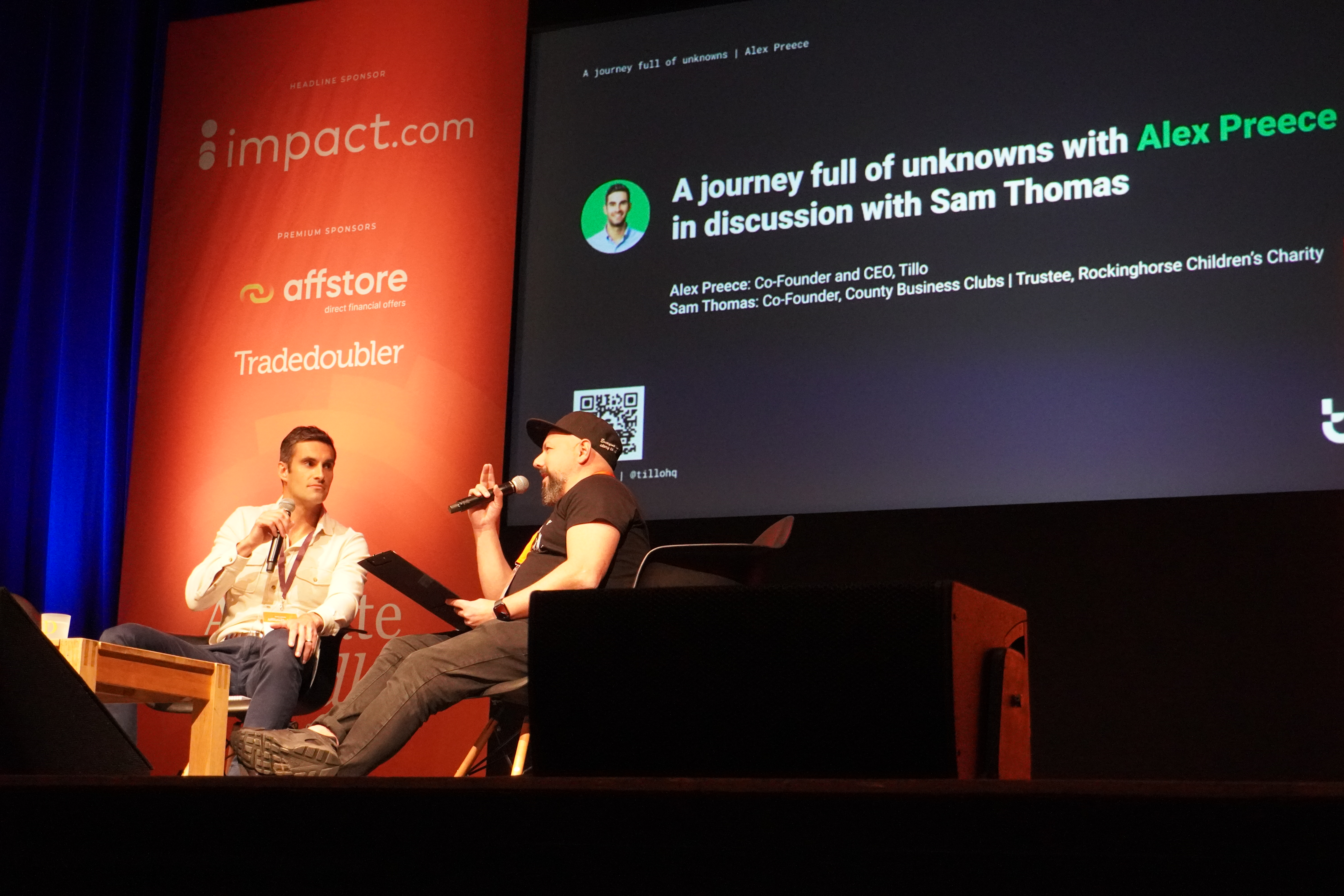 Alex Preece, seated on the left, speaking with Sam Thomas onstage at Brighton Dome