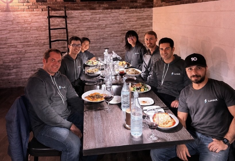 The LuminX team, including Alex Senemar, gathered around a restaurant table