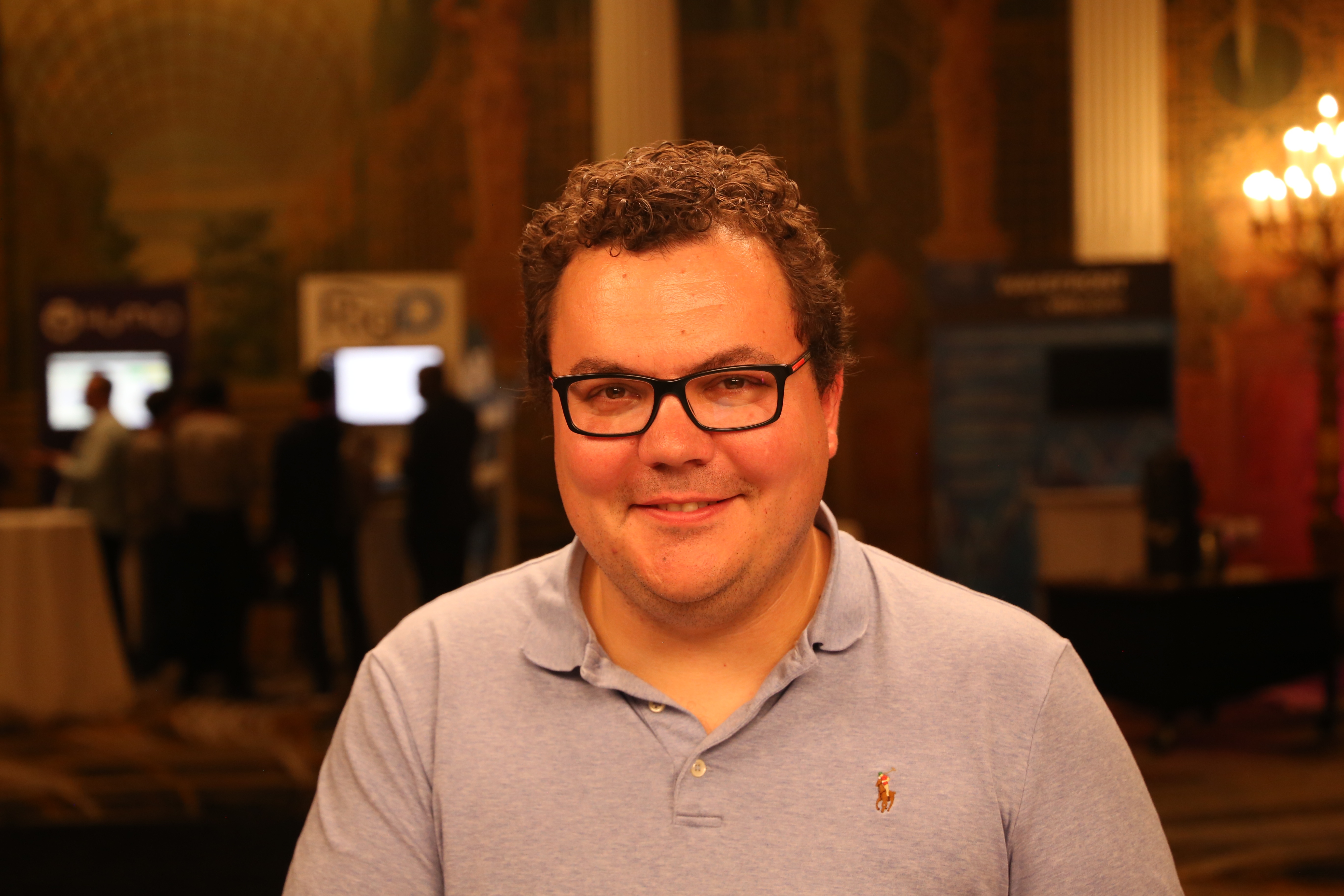Alex Solomon at PagerDuty Summit in 2018, wearing glasses and a light blue polo shirt