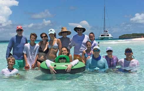 Alex Stancioff, at the far left in the back row, with family and friends in shallow water in the Abacos, Bahamas