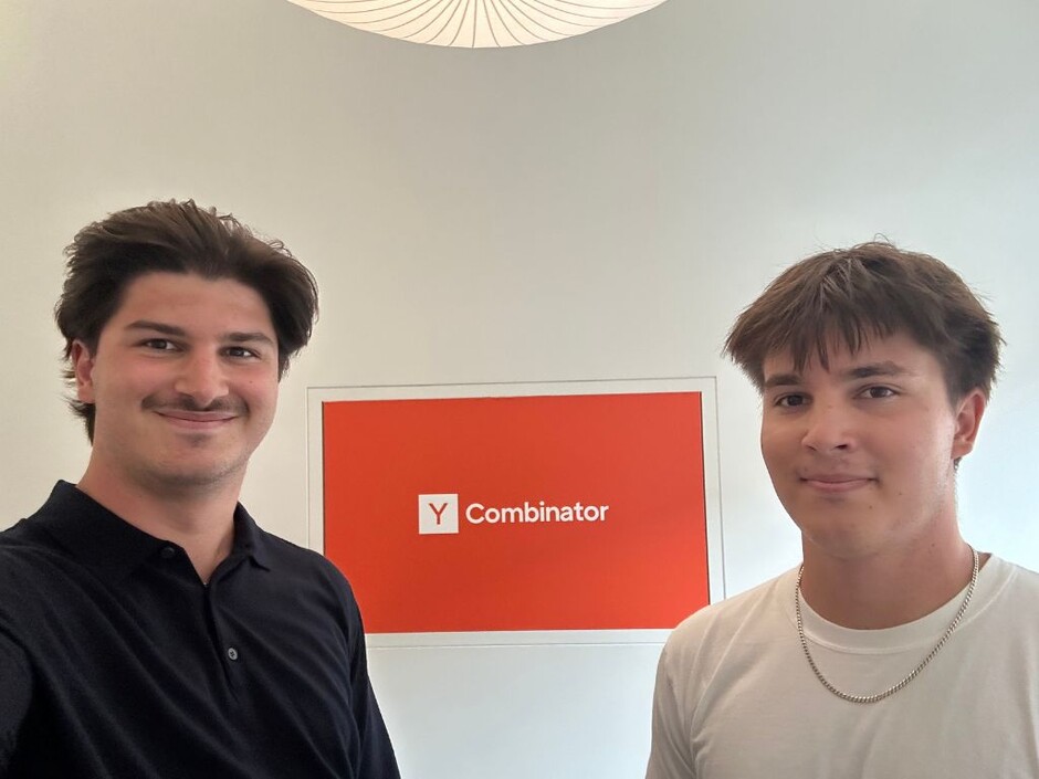 Alex Stroe and Andreas Stroe standing beside a Y Combinator sign