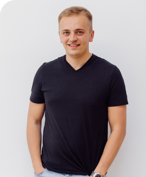 Alex Vasylyk standing in a black T-shirt with his hands in his pockets