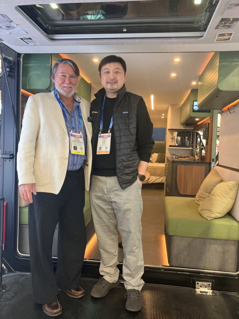 Alex Xiao and Gordon Cruise McBride standing inside the Evotrex PG5 at CES 2026