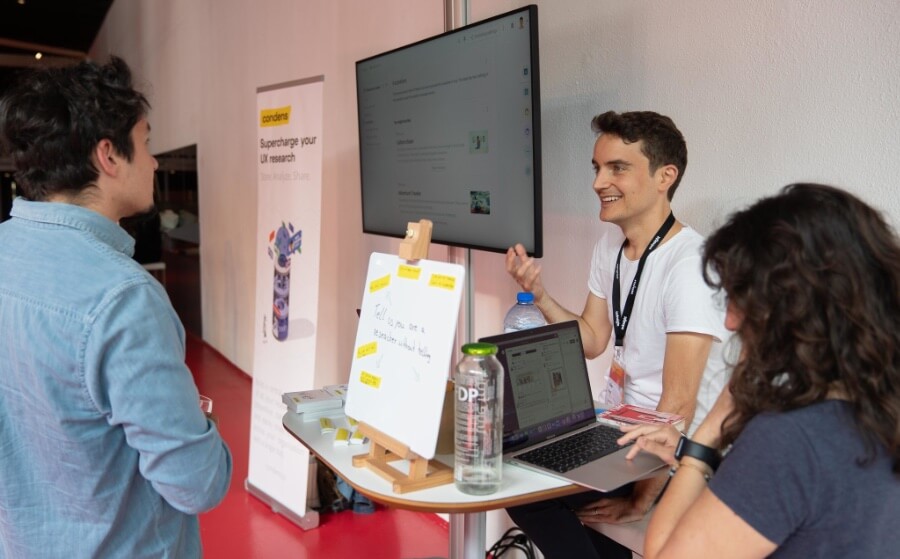 Alexander Knoll talking with visitors at a Condens event booth