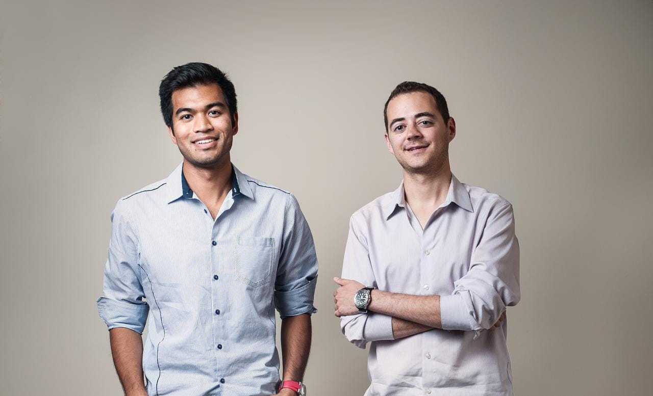 Alexander Mittal and Boris Silver standing together in light button-down shirts