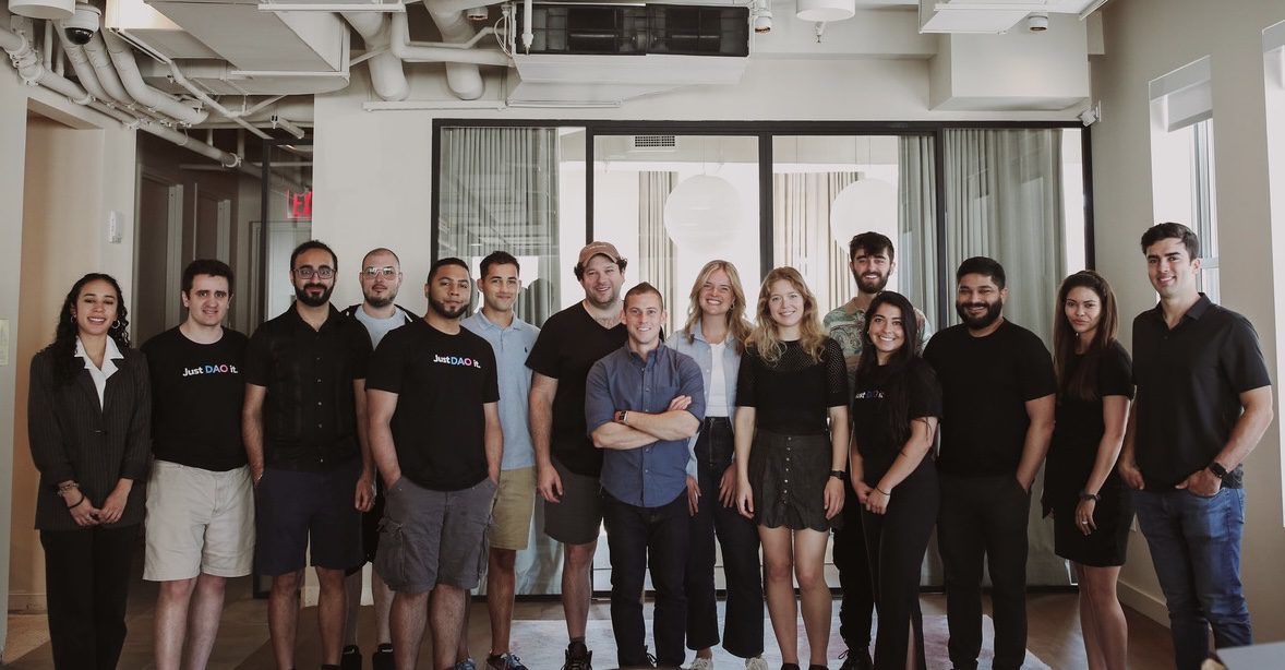 The Upstream team standing together in a bright office