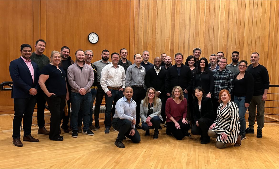 Insurance Supermarket International team gathered in a wood-paneled room at the Kingbridge Centre