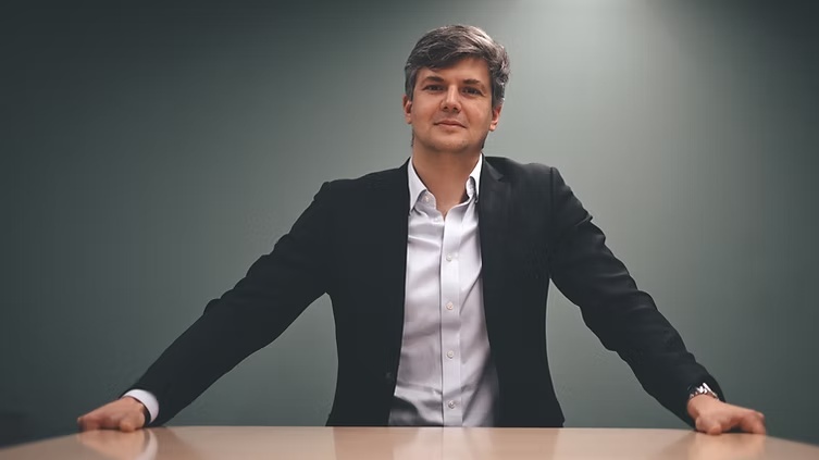 Alexandre de Vigan seated at a table in a dark jacket