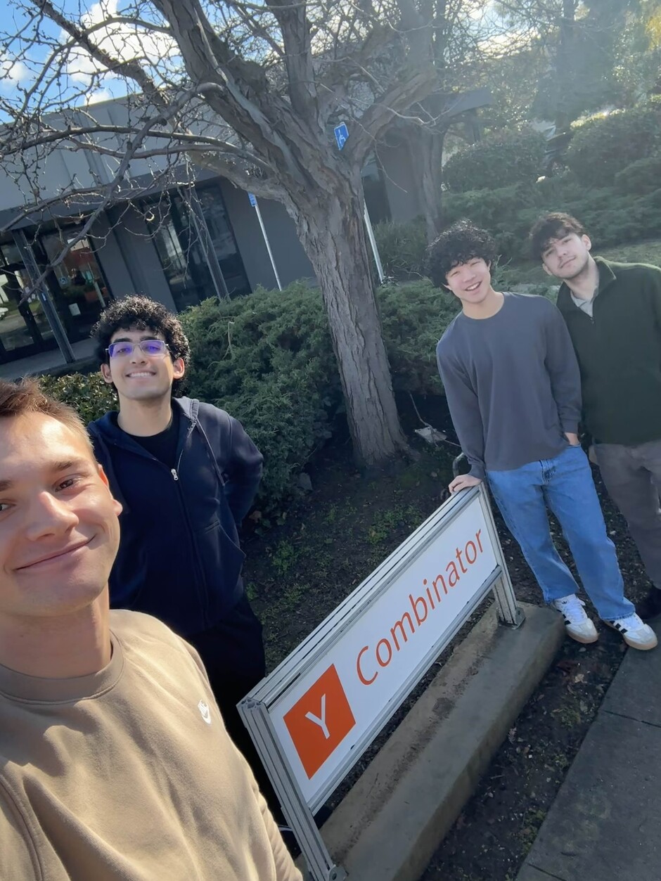 Shofo co-founders Braiden Dishman, Alexzendor Misra, Bryan Hong and Andre Braga beside a Y Combinator sign