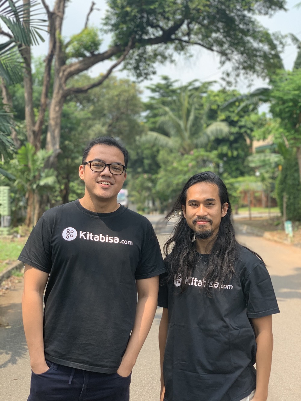 Alfatih Timur, left, and Kitabisa co-founder Vikra Ijas outdoors in matching Kitabisa shirts