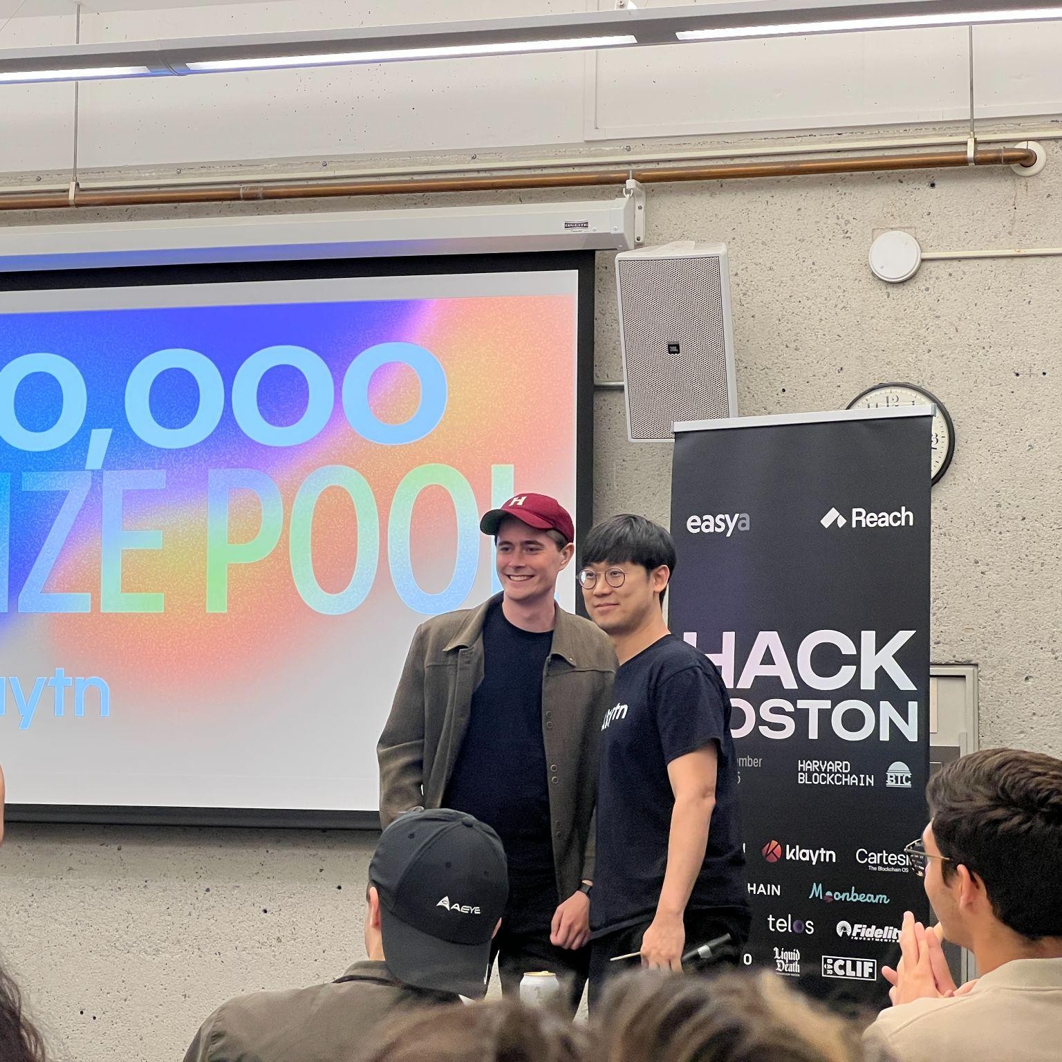 Alfred Wahlforss, wearing a Harvard cap, at a blockchain hackathon prize presentation
