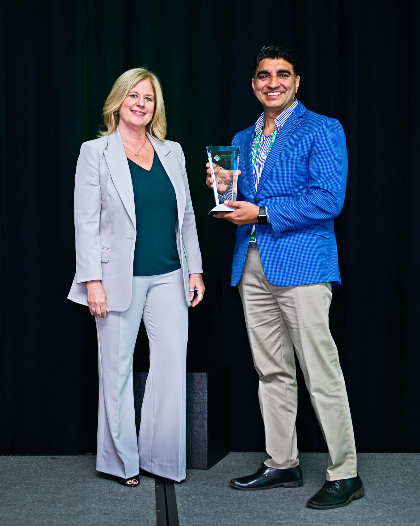 Dexcom CIO Stacey Stewart and Algoworks representative Manish Soni holding an award