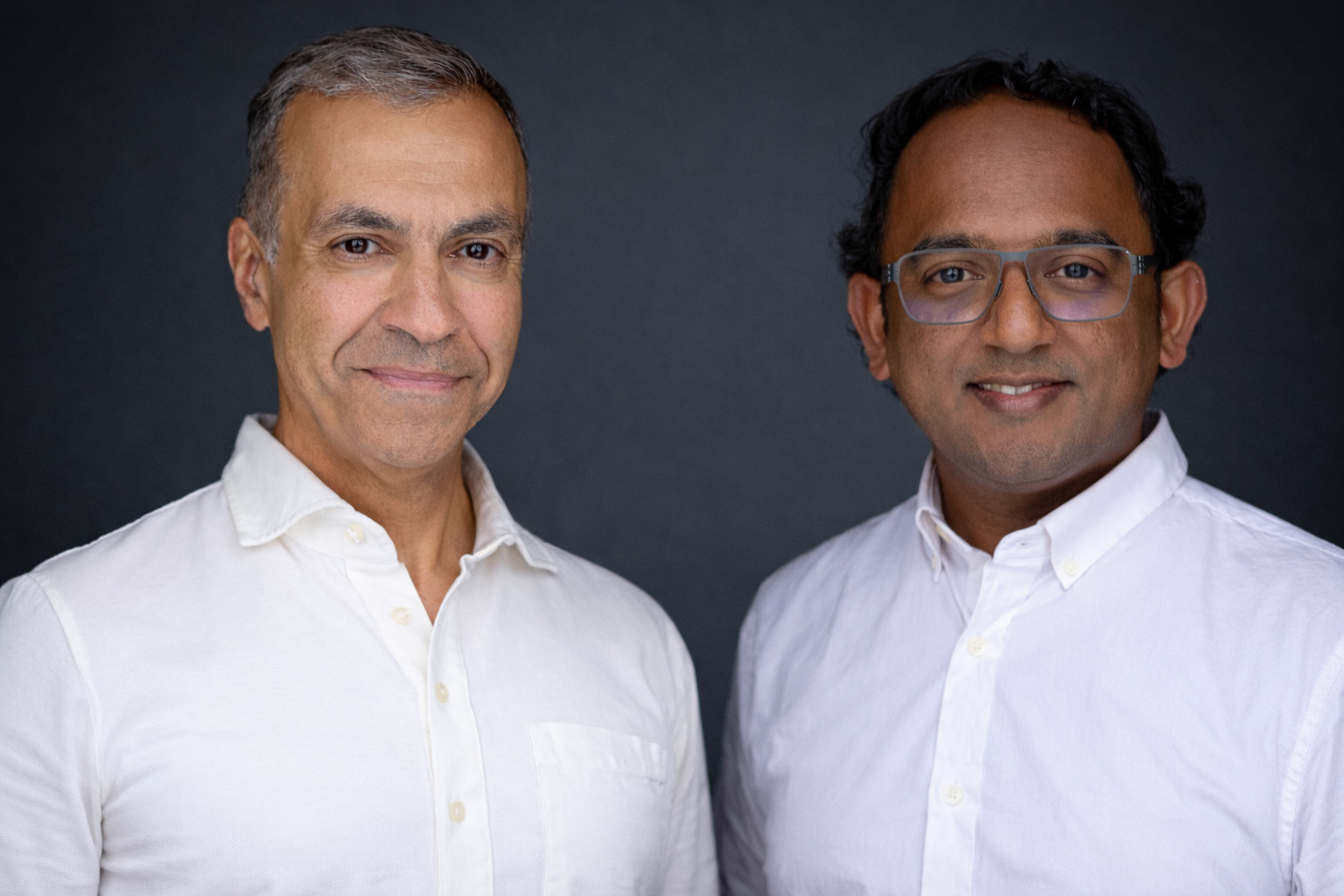 Ali-Reza Adl-Tabatabai and Gautam Korlam, the founders of Gitar, standing together against a dark studio background