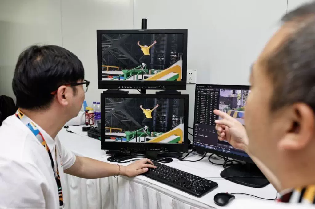 Technicians examine skateboarding footage on monitors during Alibaba Cloud multi-camera replay testing in Shanghai