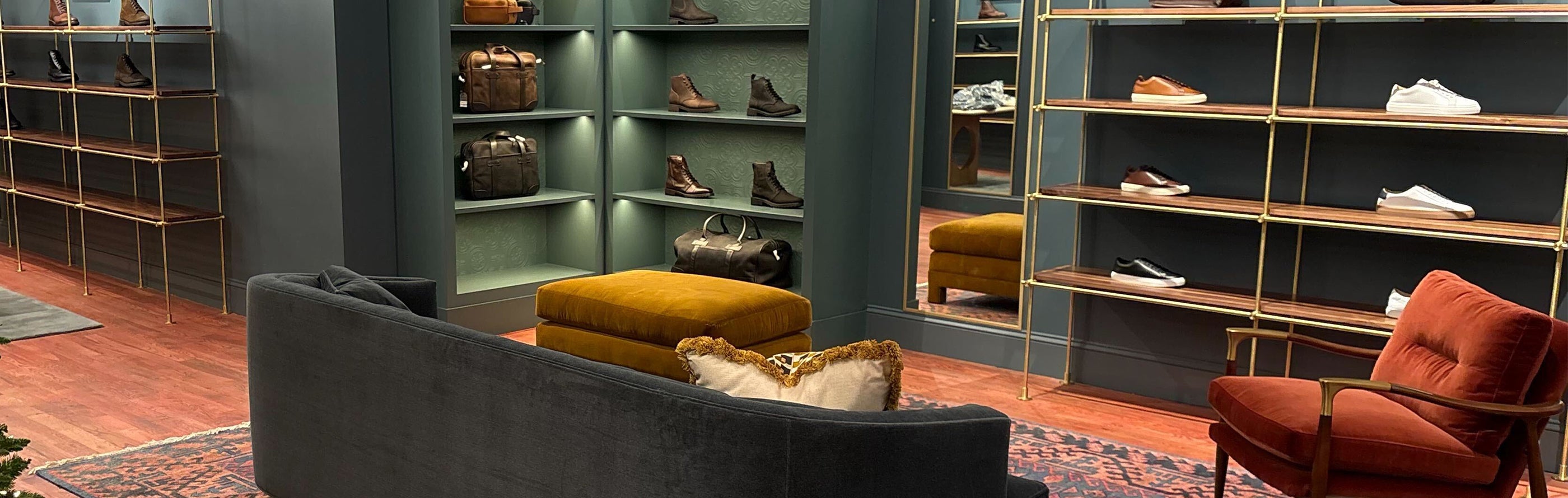 Interior of Thursday Boot Company's SoHo store, with leather shoes and boots arranged along long wall displays