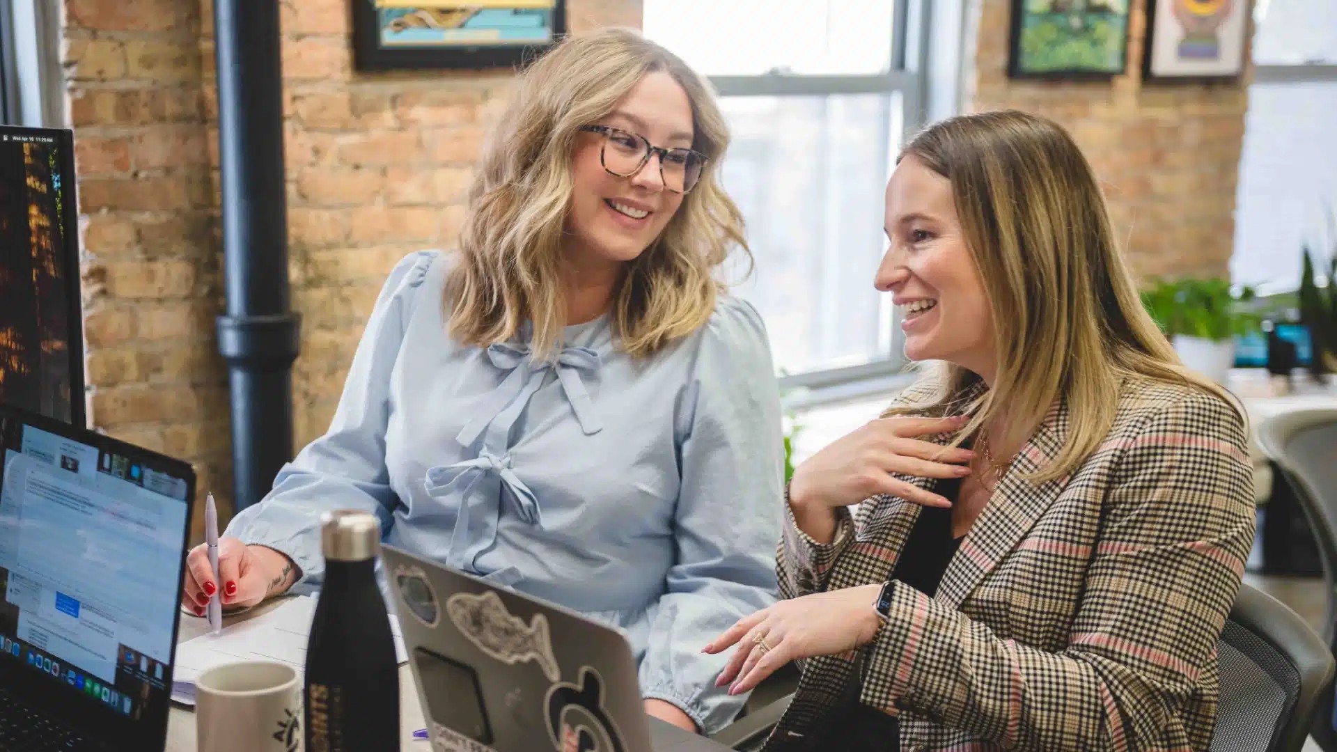 All Points Public Relations team members collaborating at laptops in the Chicago office