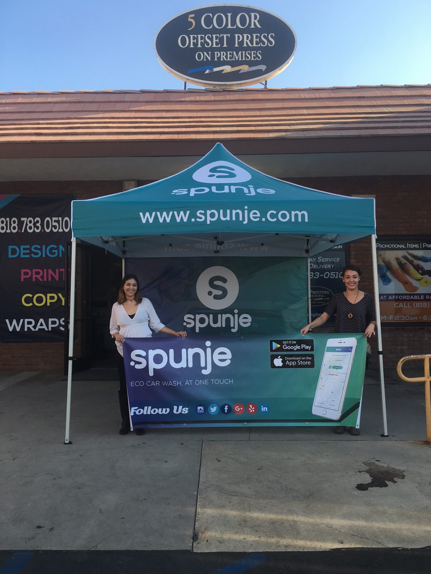 Spunje branded tent, backdrop and banner displayed outside the print shop