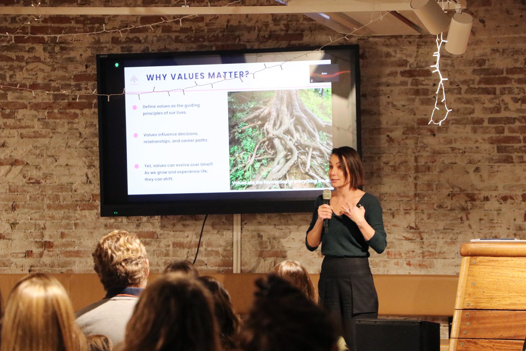 Alla Idrisova addressing an audience beside a presentation headed Why Values Matter