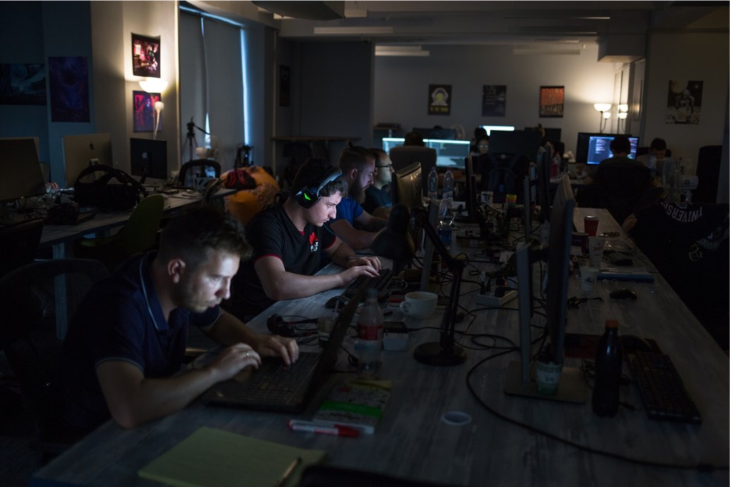 Developers working at shared desks in an early Mad Devs office