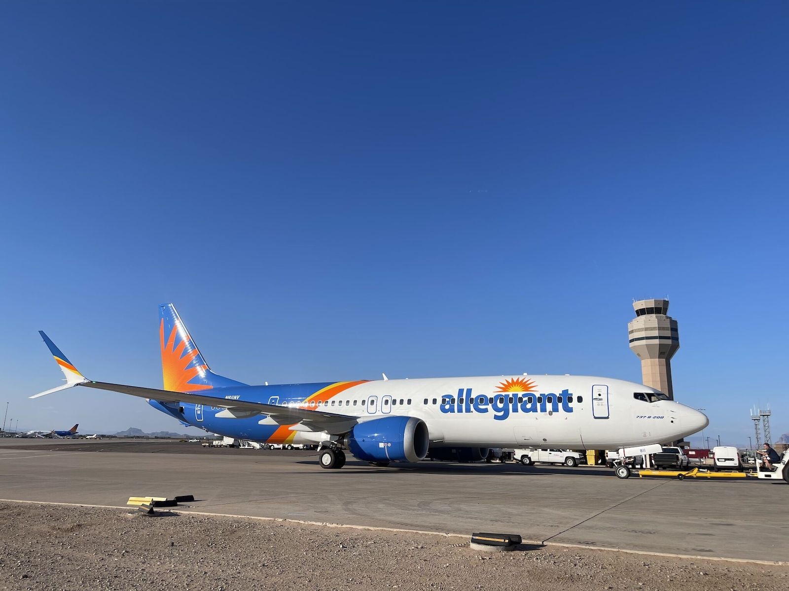 Allegiant’s first Boeing 737 MAX, N811NV, parked on an airport apron beneath a clear blue sky