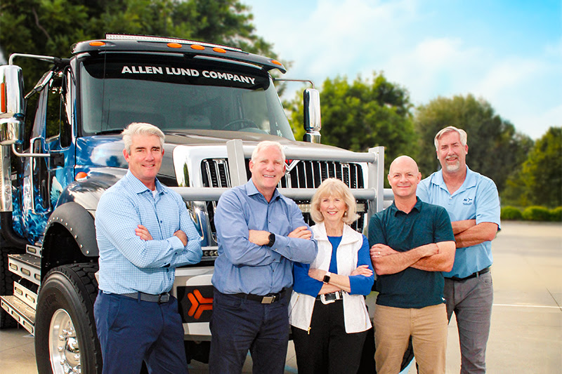 Members of the Lund family standing beside the company’s Big Al truck
