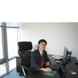 Archival photograph of Allen Yang seated at an office desk