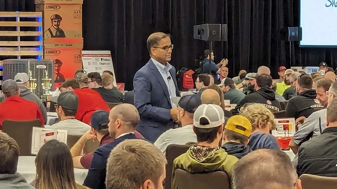 Alok Maskara walking among attendees at a Lennox VisionTECH conference in Wisconsin Dells