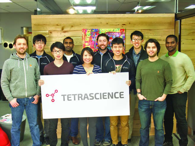 The early TetraScience team gathered around a company sign in its Boston office