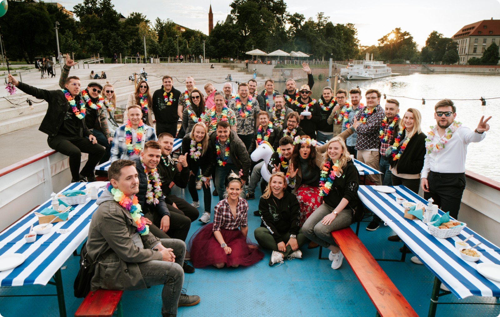 Alokai team gathered on a boat at a company event