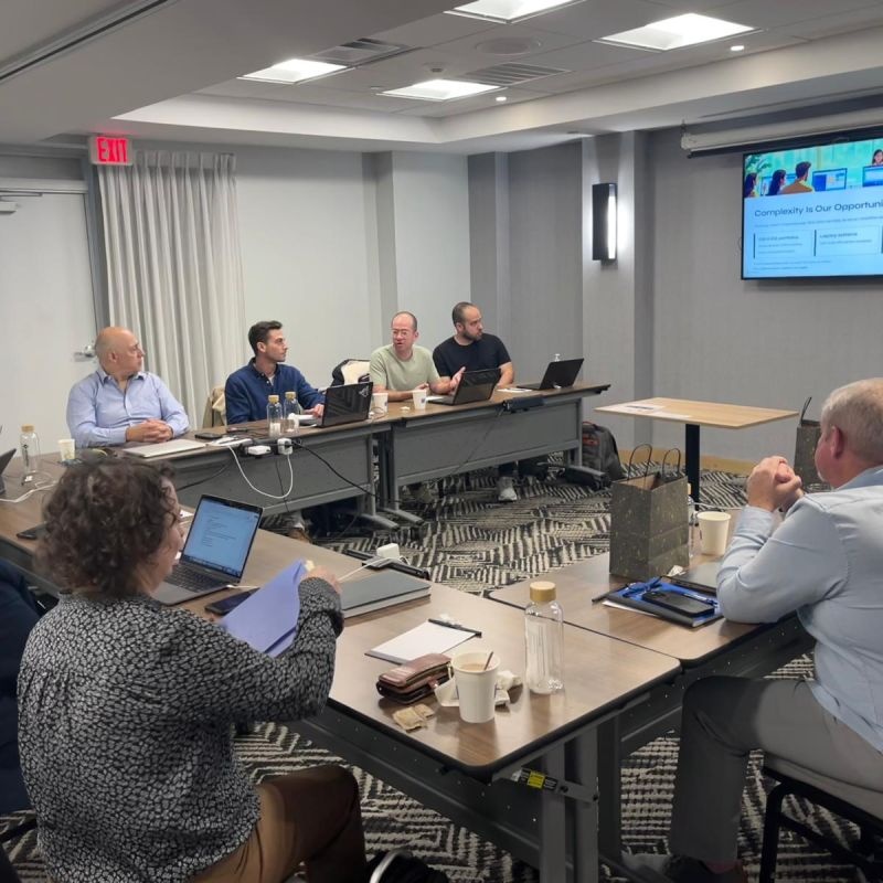 The enSights leadership team around a conference table during its Austin gathering