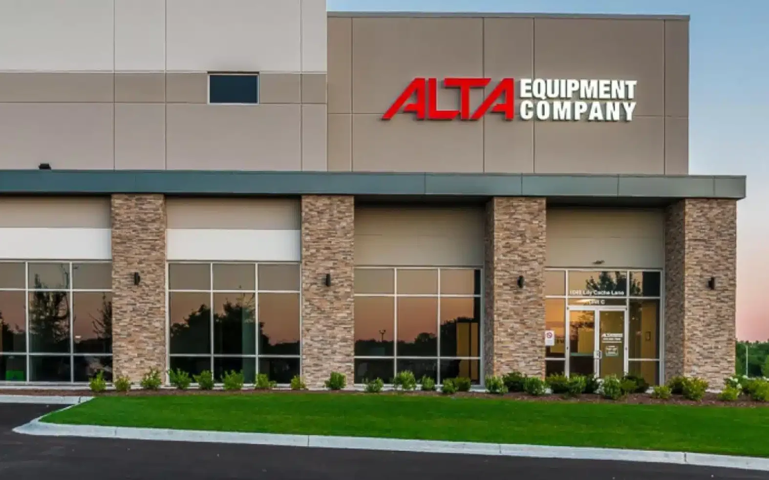 The entrance to an Alta Equipment Company branch, with the Alta sign above stone columns.