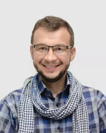 Altoros founder Renat Khasanshyn, wearing glasses and a checked shirt